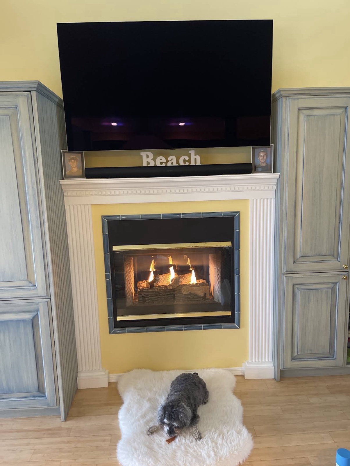 TV over fireplace with soundbar and decor accents