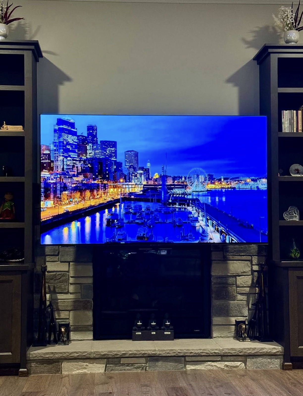 Stone fireplace with cabinet built-ins and mounted TV