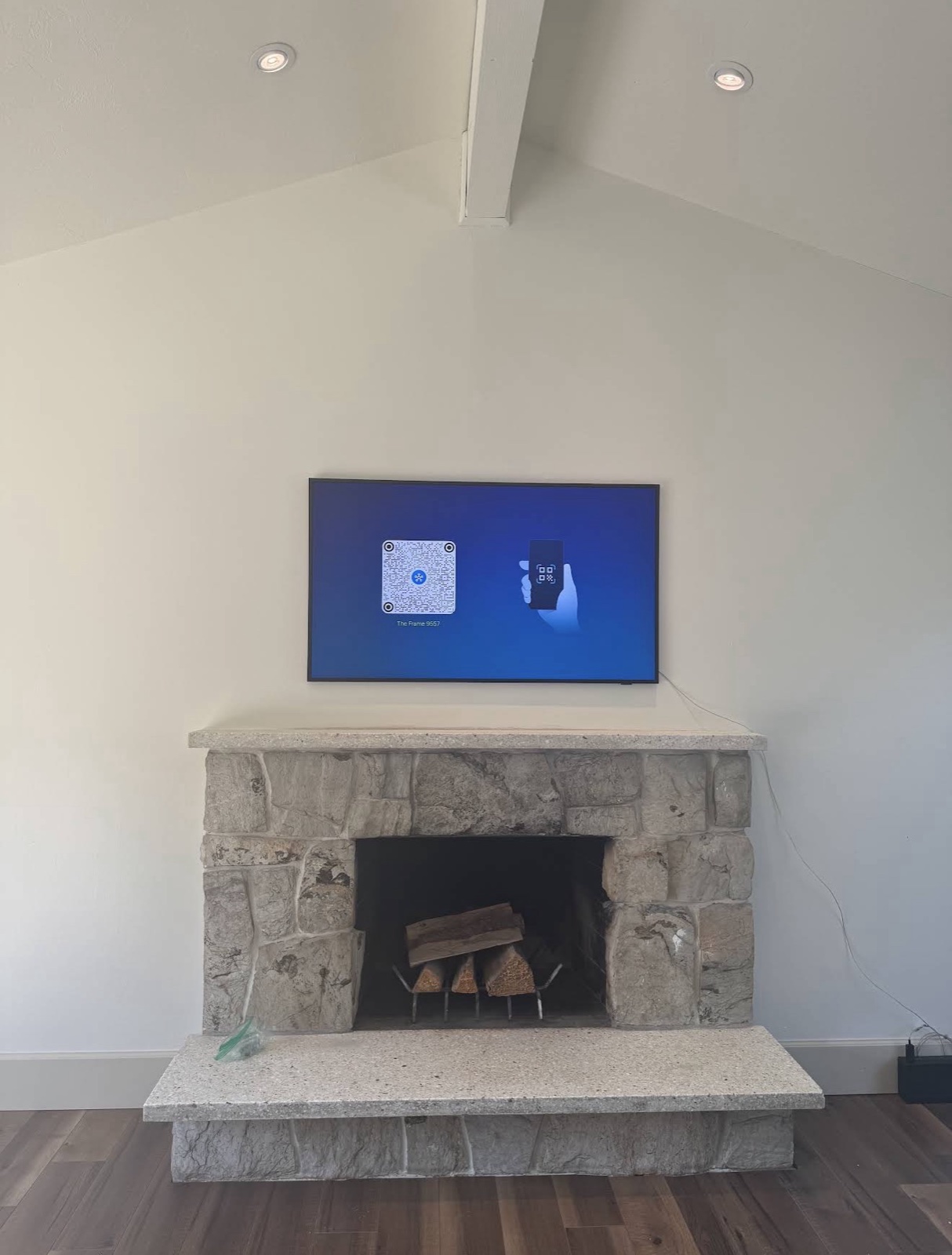 Vaulted ceiling stone fireplace, minimalist TV install